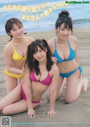 A group of three women in bikinis sitting next to each other.