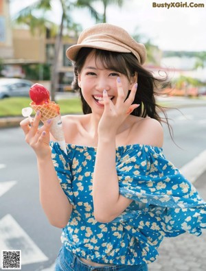 A woman in a green dress posing for a magazine.