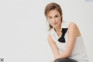 A woman in a black and white bra posing for a picture.