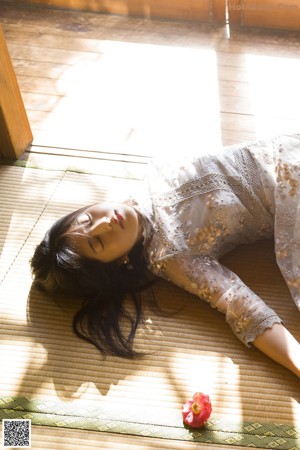 A woman laying on the floor in a room.