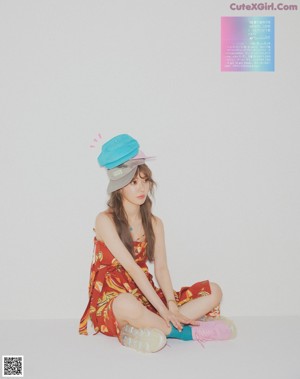 A woman in a blue dress holding a stuffed animal.
