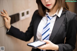 A woman sitting at a desk with a laptop computer.