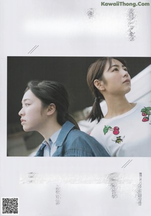 Two young women standing next to each other in white dresses.