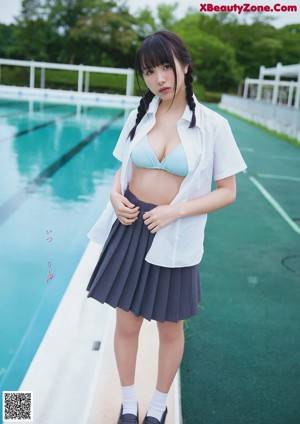 A woman in a blue bikini sitting in a pool.