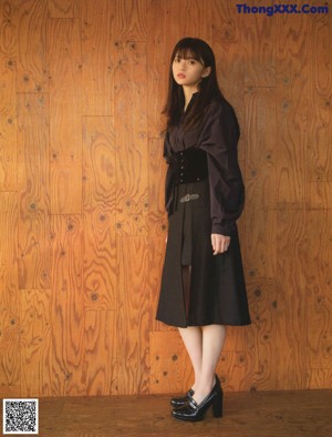 A woman standing on the steps of a building.