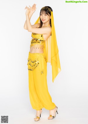 A woman in a pink belly dance outfit posing for a picture.