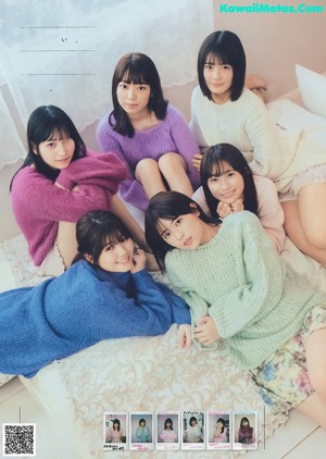 A group of young women sitting on top of a white couch.